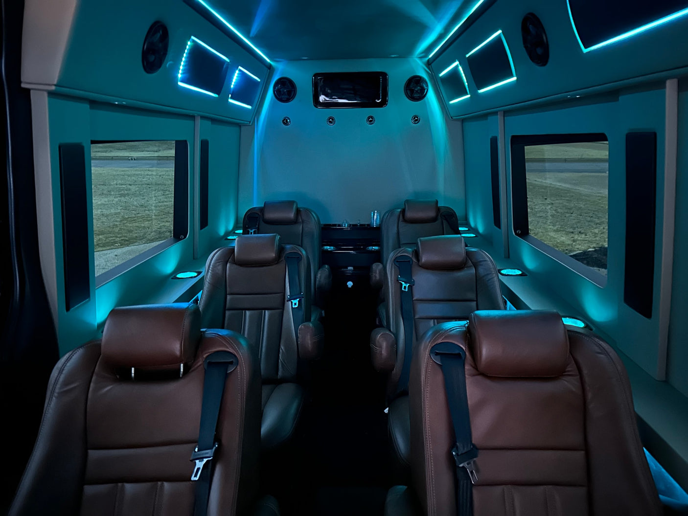 featuring ambient blue lighting & entertainment.|Luxury RV rental interior with a large TV showing Netflix