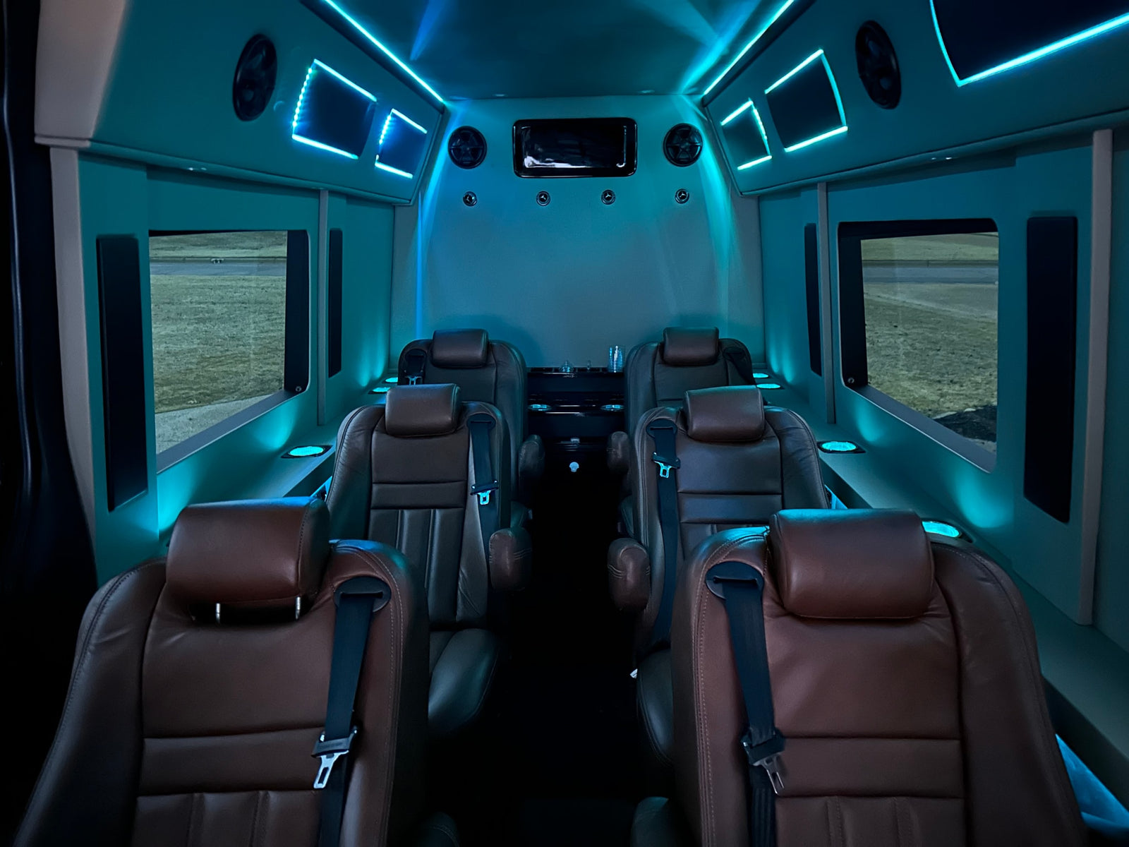 featuring ambient blue lighting & entertainment.|Luxury RV rental interior with a large TV showing Netflix