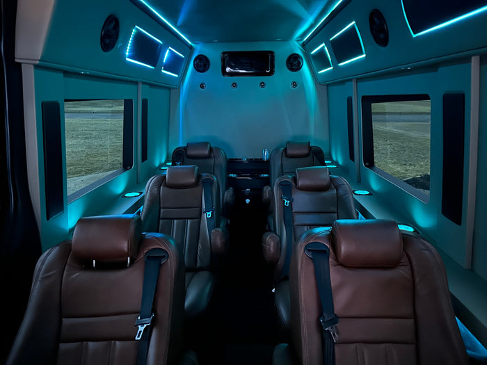 featuring ambient blue lighting & entertainment.|Luxury RV rental interior with a large TV showing Netflix