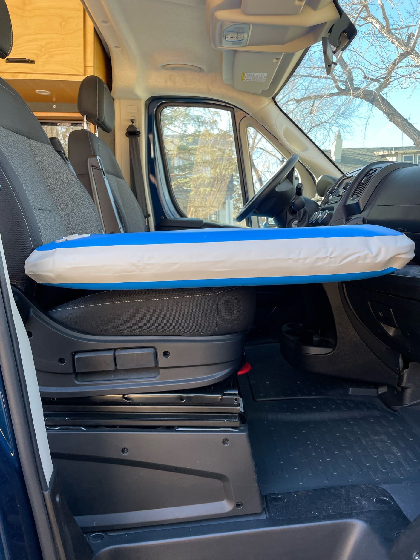 RV rental interior with a blue & white inflatable float on the passenger seat, ready for adventure.