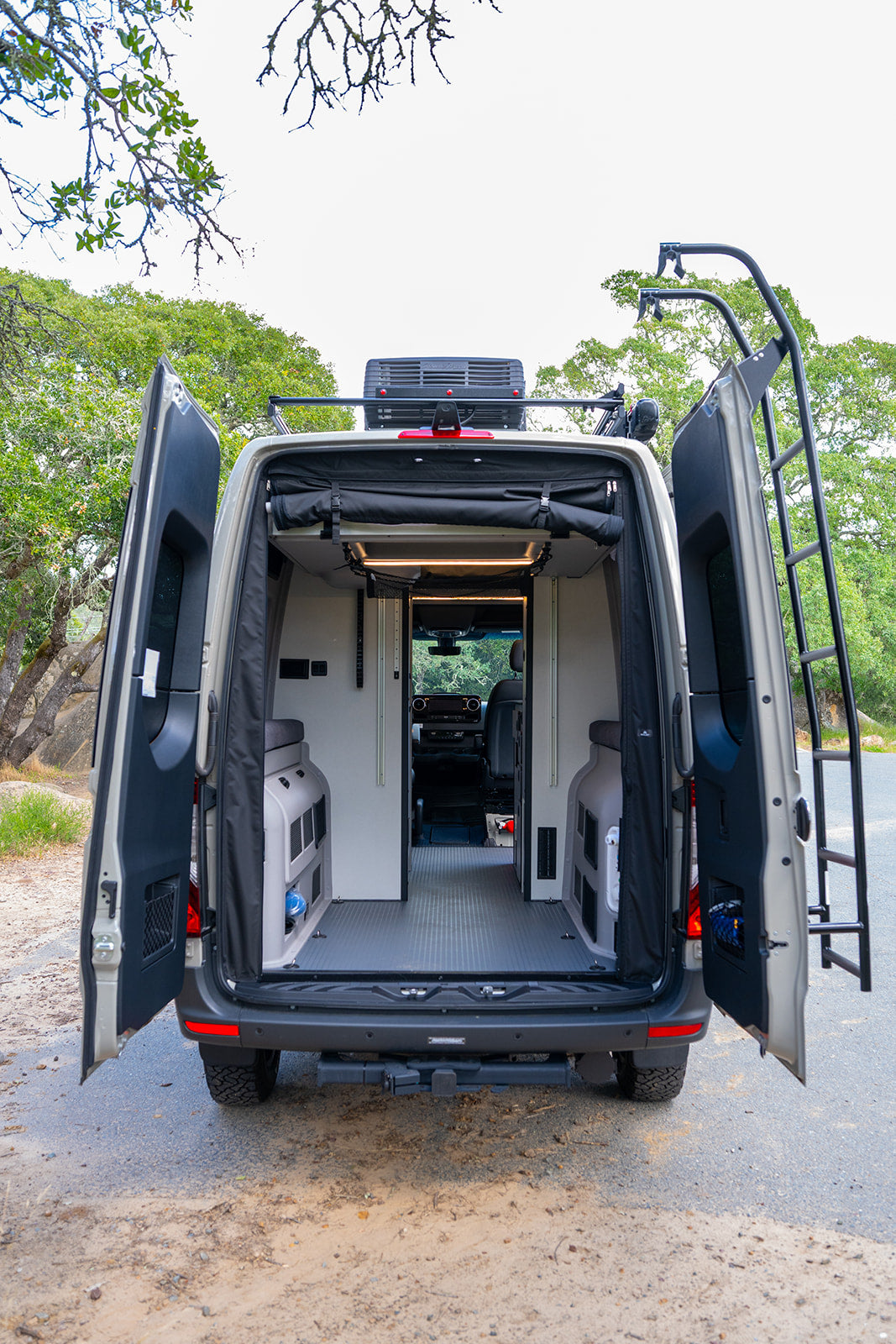 Open back doors reveal a fully equipped camper van interior, ready for your next rv rental travel adventure!