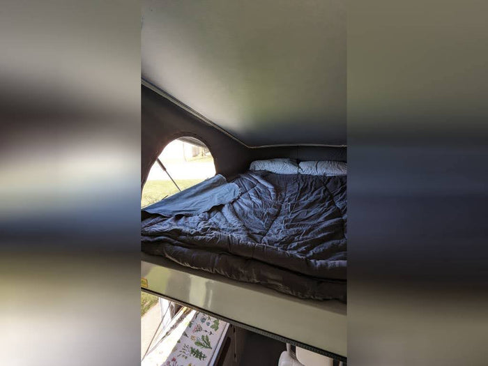 quilted seats and control panels for a comfortable journey.|This compact RV rental bathroom features a white shower curtain