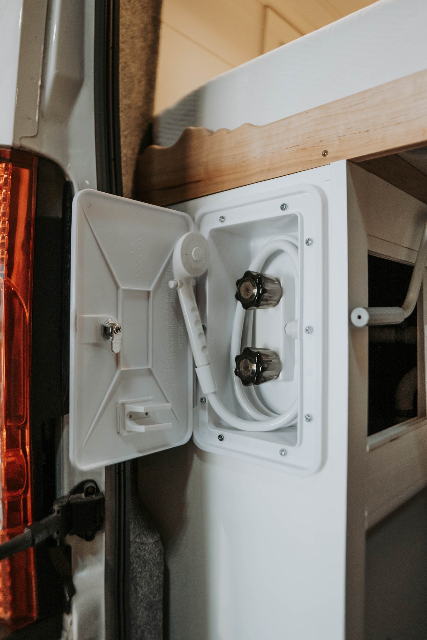 and warm wooden accents for comfortable travel.|RV rental: A clever light wood pull-out desk with an open storage drawer and cozy bench seating maximizes this camper's space.|Functional camper van interior for RV rental. Features dual monitors