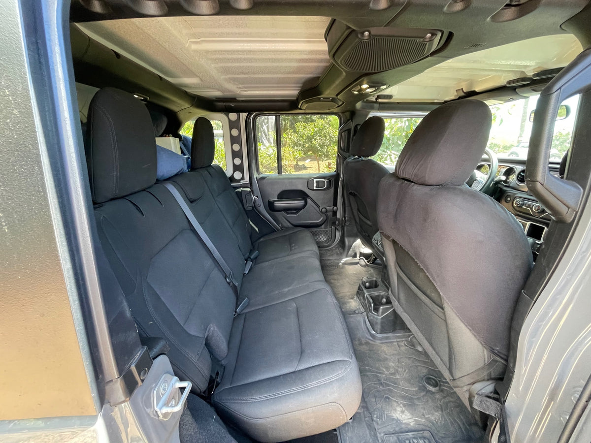 The rugged interior of a Jeep, perfect for an RV rental adventure. Black seats and all-weather floor mats are visible. — photo 8