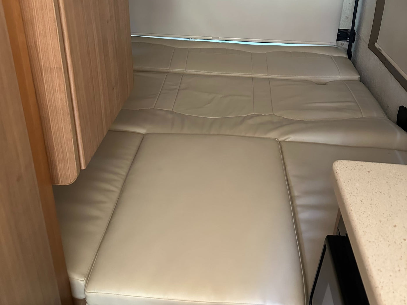 and a 'BAD DOG' sign. Ready for your next adventure.|Cream captain's chairs within an RV rental interior — photo 6