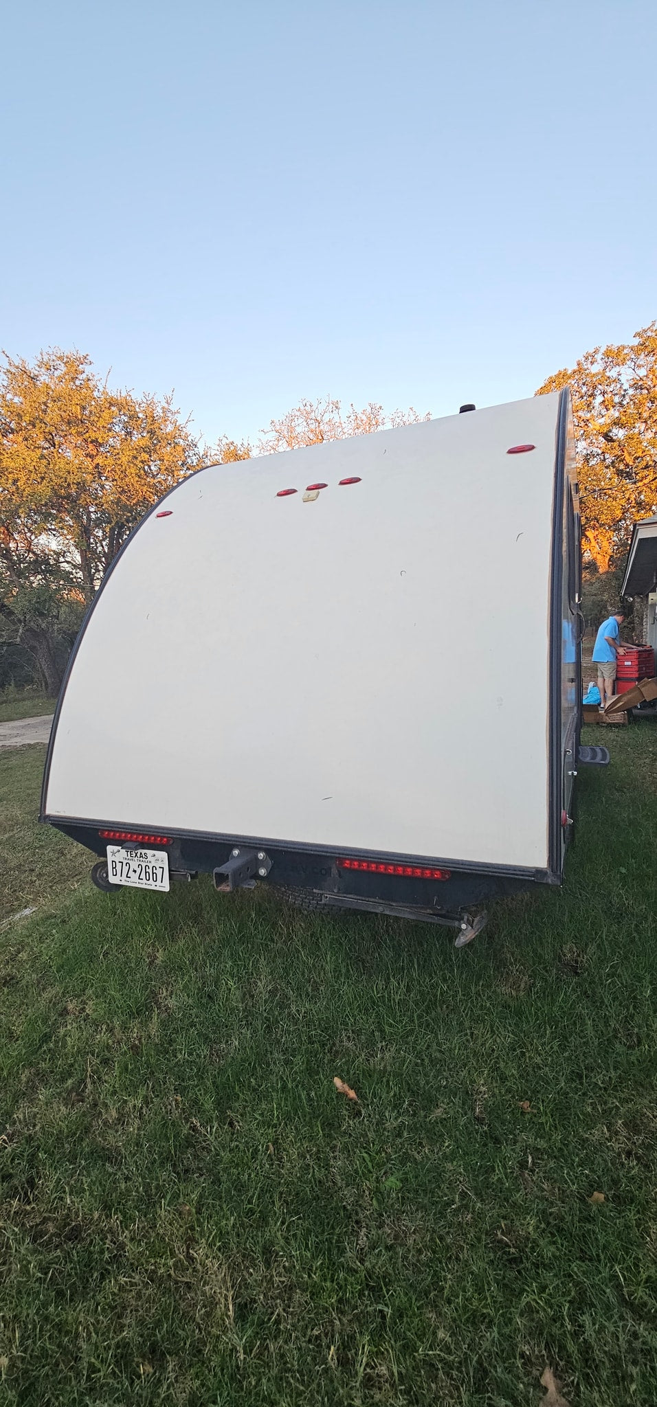 with a person loading items in the background.|Cozy RV rental bunk beds with a ladder