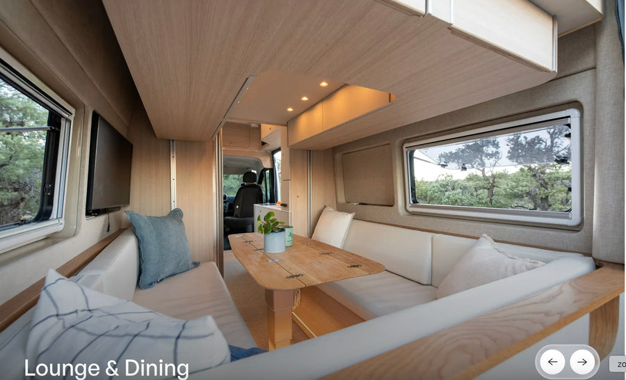 Modern rv rental interior: a spacious lounge and dining area with light wood