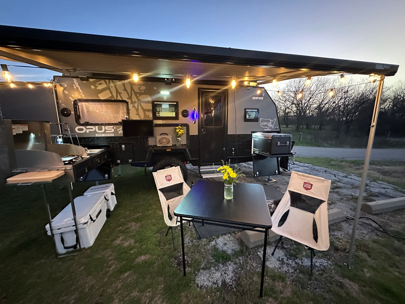 featuring blue bedding and outdoor views from the windows.|RV rental interior: bunk beds with blue bedding