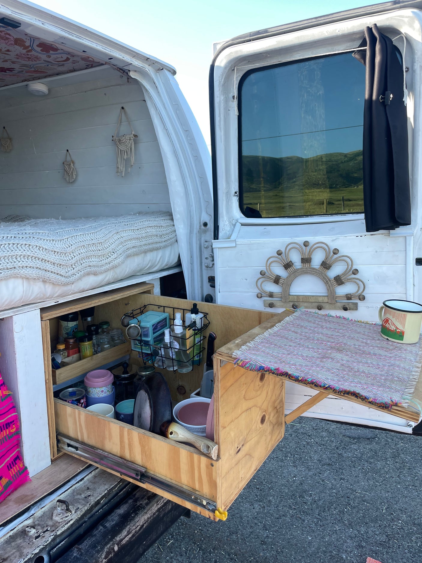 This RV rental offers compact living: a cozy bed & pull-out kitchen with all essentials for your adventures.