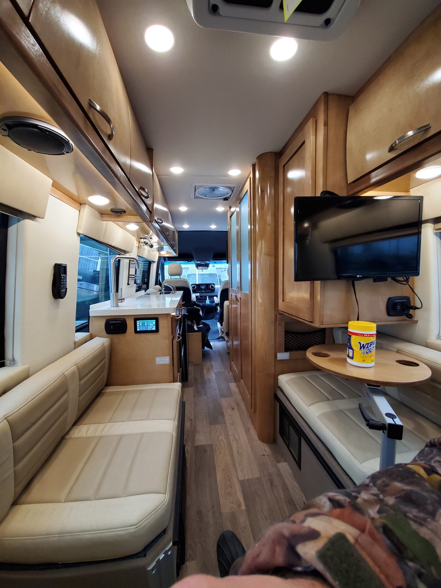 steps & a bright light bar. Perfect for your next rv rental adventure.|Explore this RV rental's spacious interior: cream leather seats