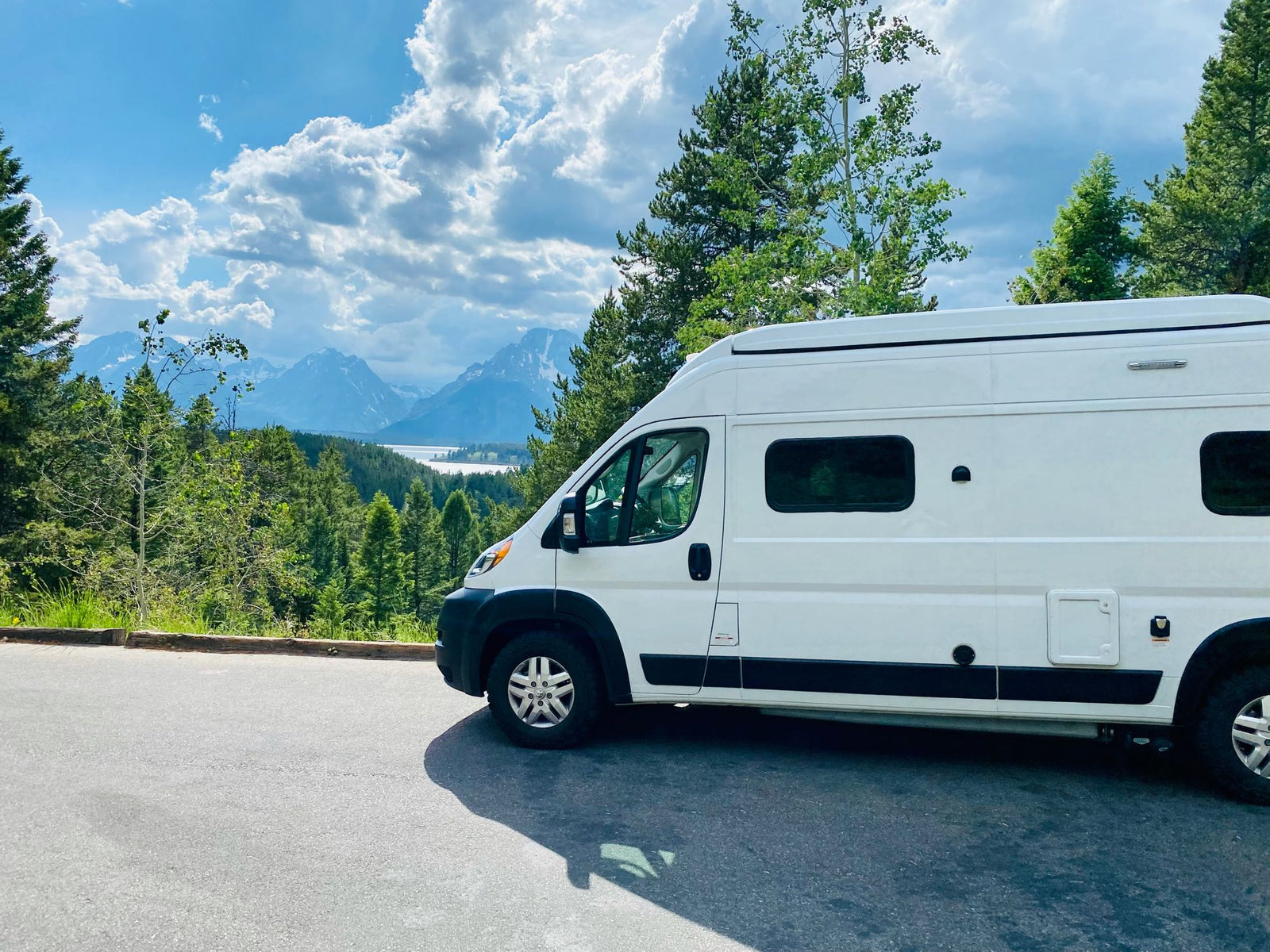 and scenic lake view through mesh screens.|Cozy RV rental sleeping area with a quilted bed
