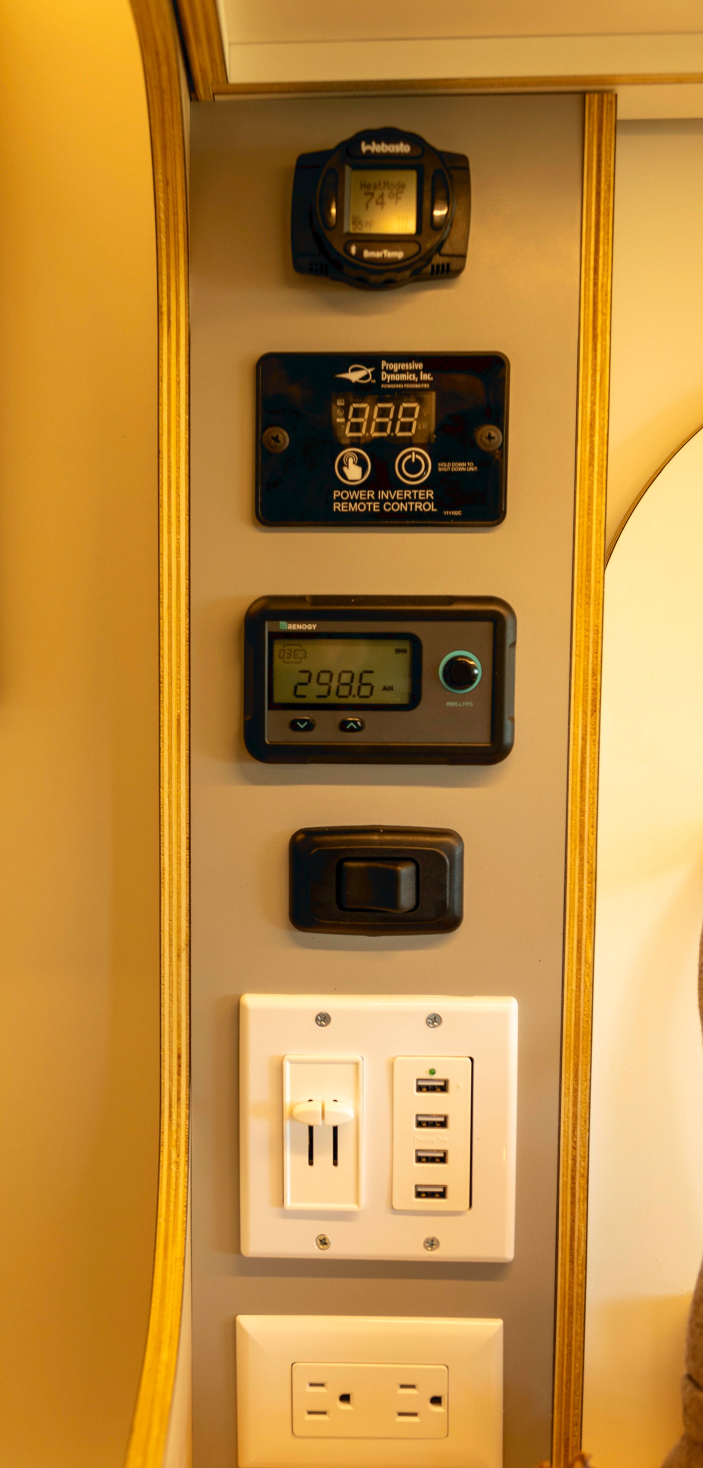 RV rental control panel: Webasto thermostat, power inverter, Renogy battery monitor, USB ports, and AC outlets for comfort.