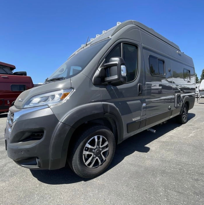 and a living area leading to the cockpit.|Inside your RV rental: a compact kitchen featuring a two-burner stove