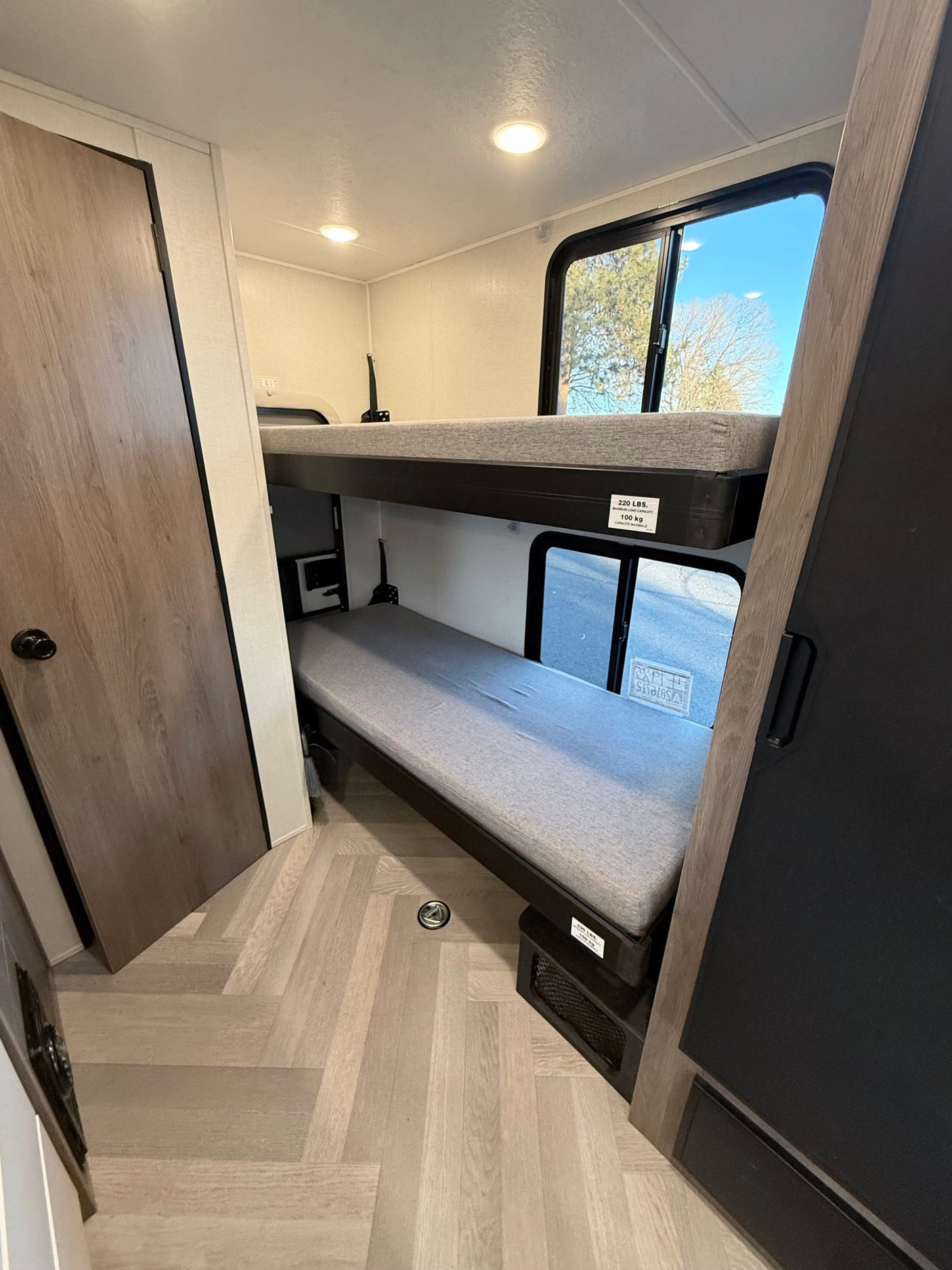 Cozy bunk beds inside an RV rental with a 220 lbs capacity per bunk, perfect for family sleeping.