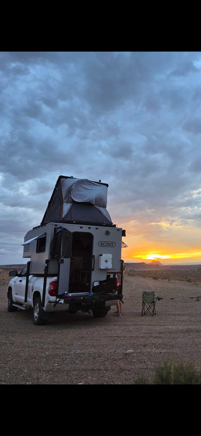 This rv rental truck camper with a rooftop tent offers epic sunset views. Perfect for camping & outdoor adventures.