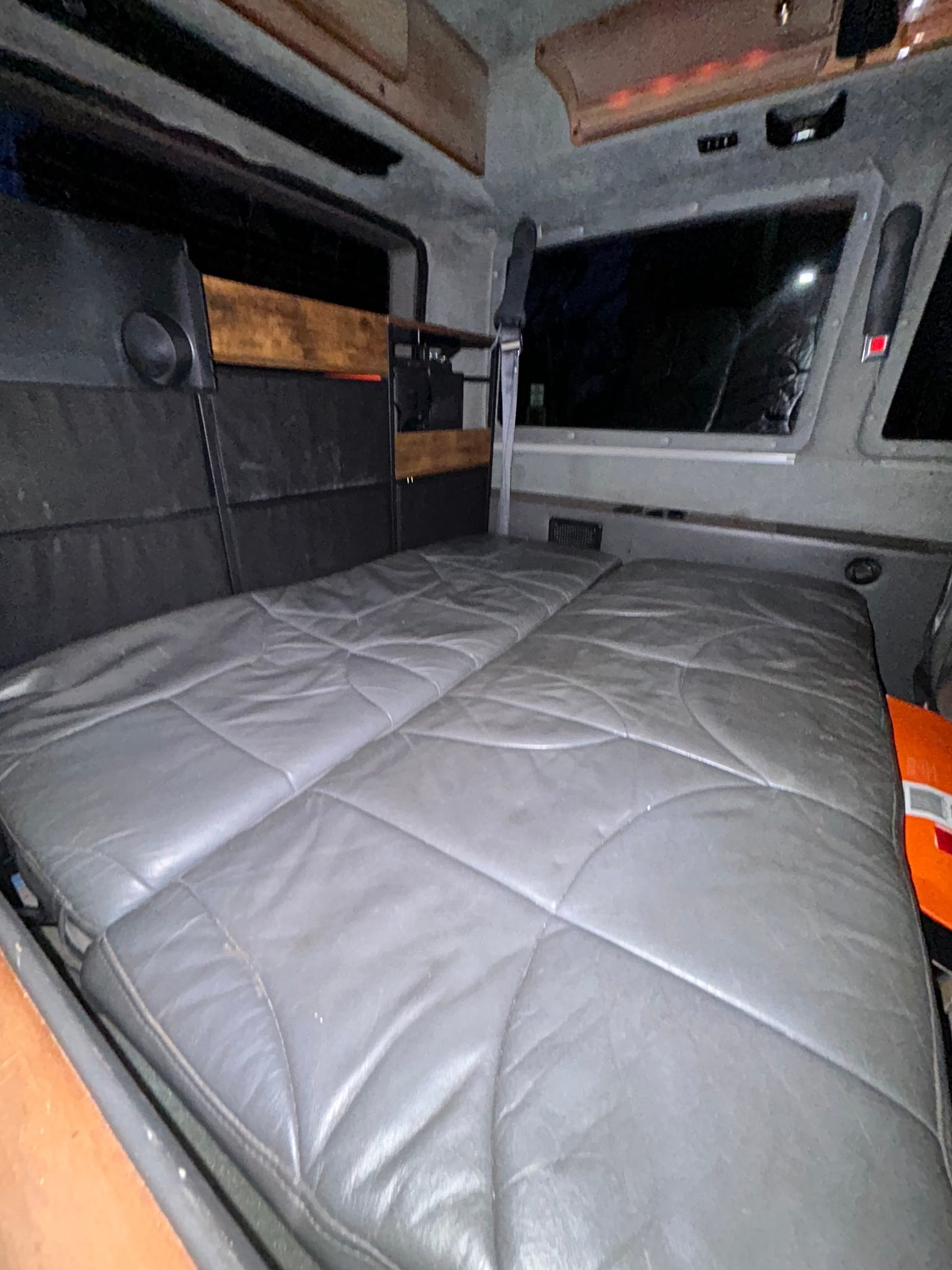 parked on a mountain road with green hills & blue sky. Great for trips!|A red Astro van with wood paneling