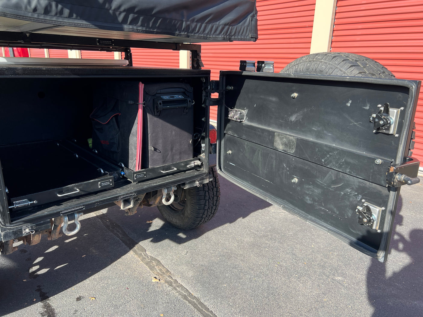 Get ready for your RV rental adventure! This off-road trailer boasts organized pull-out storage, a fridge, and rooftop tent.