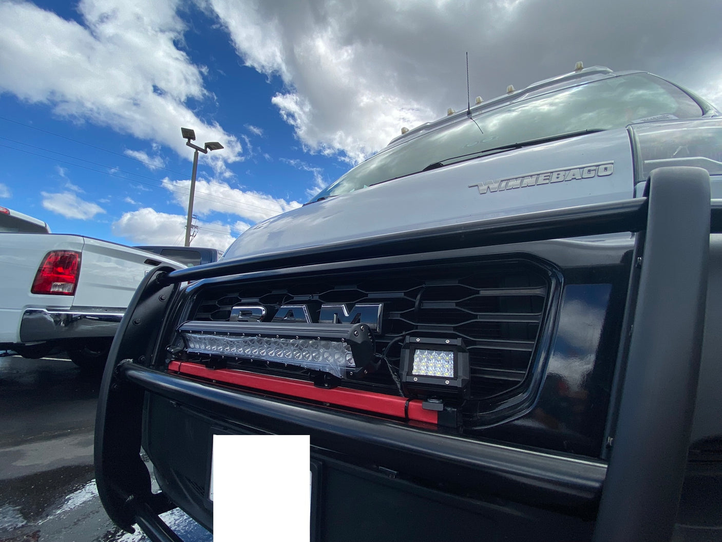 Winnebago Ram RV for rv rental, featuring a protective bull bar & bright LED auxiliary lights on the grille.
