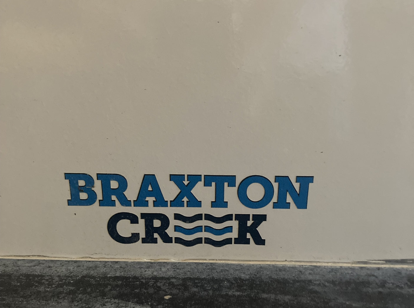 Braxton Creek RV rental logo in blue, featuring wavy lines within the 'Creek' text.