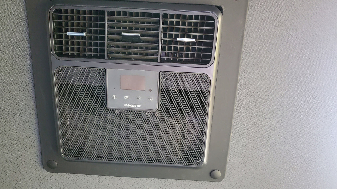 Overhead Dometic RV AC unit with vents and digital controls, ensuring comfort for your rv rental adventures.