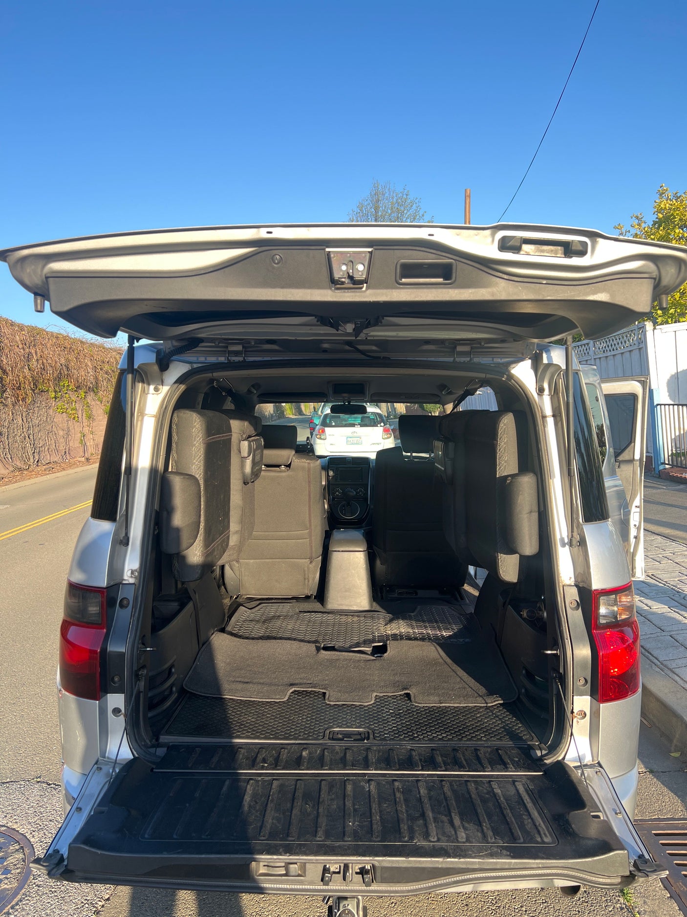 Spacious SUV interior with open tailgate, showcasing rear seats and cargo space. Perfect for your next RV rental trip.