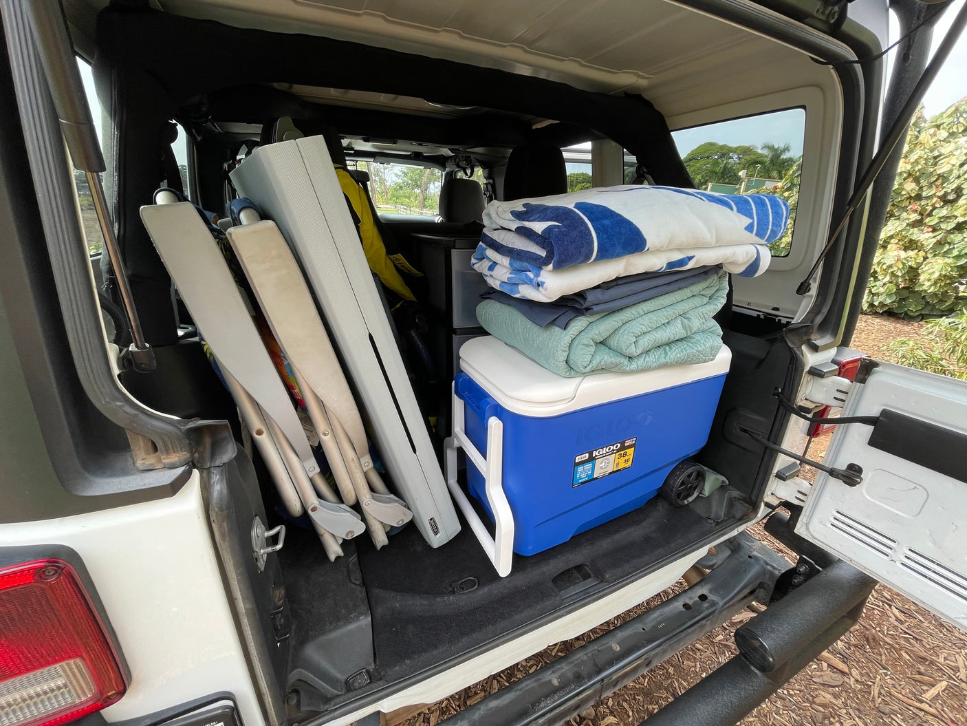 Cooler, blankets, chairs: RV rental trunk packed for an outdoor trip.