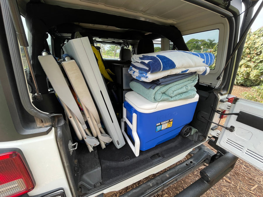 Cooler, blankets, chairs: RV rental trunk packed for an outdoor trip.