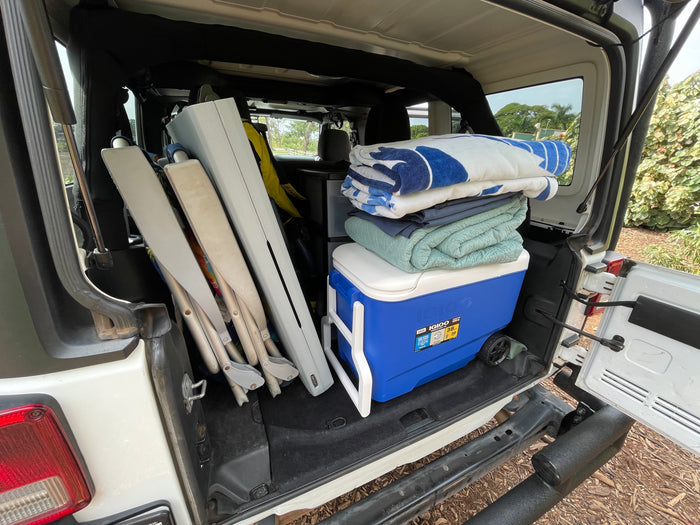 Cooler, blankets, chairs: RV rental trunk packed for an outdoor trip.