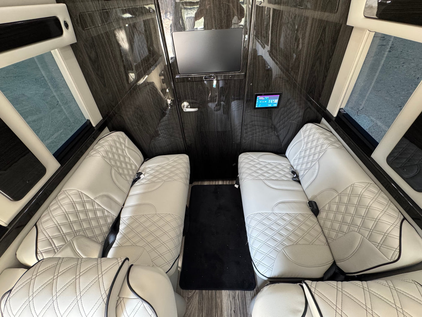 and tech controls for a premium travel experience.|Luxury RV rental interior showcasing plush