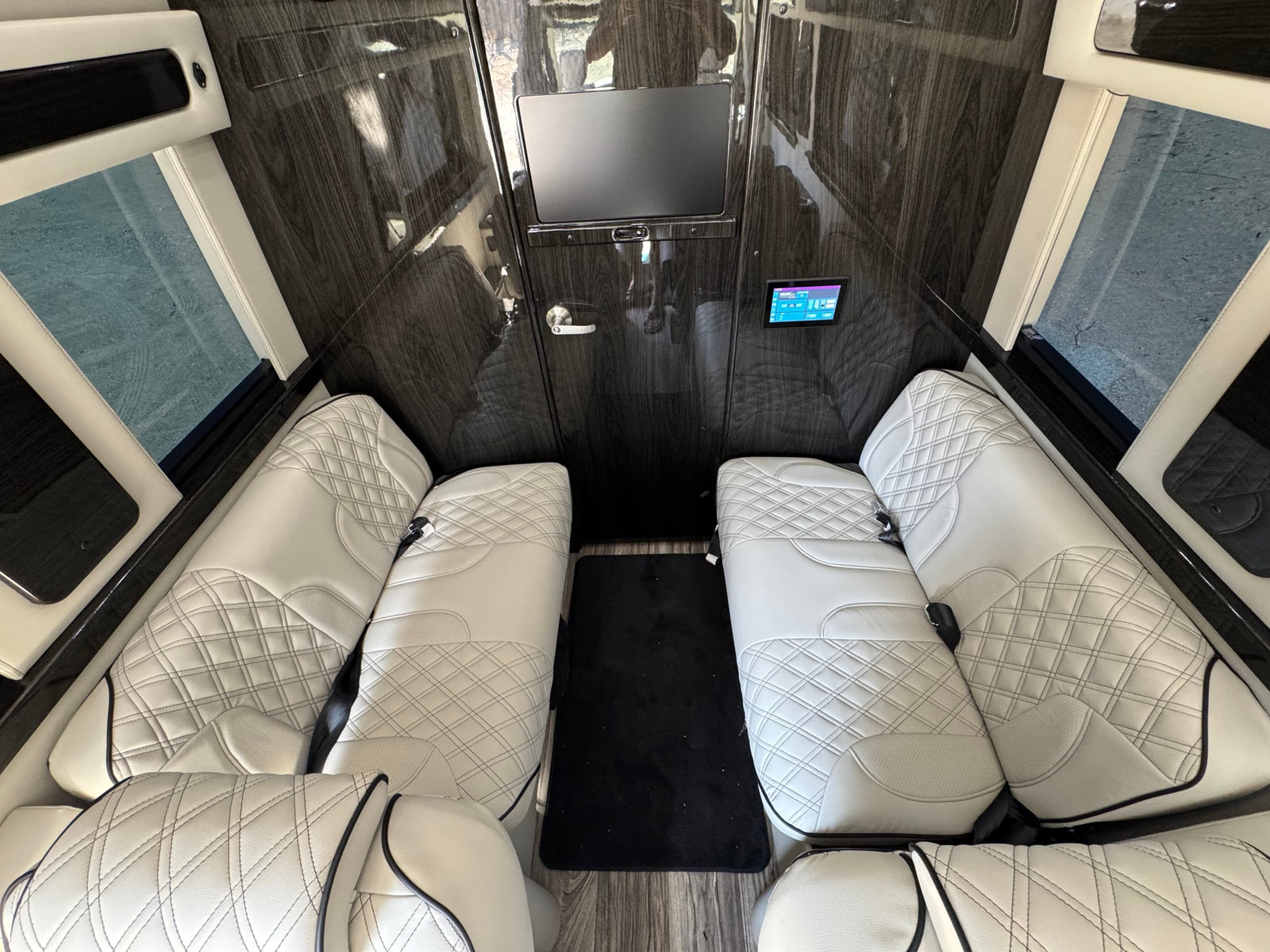 and tech controls for a premium travel experience.|Luxury RV rental interior showcasing plush