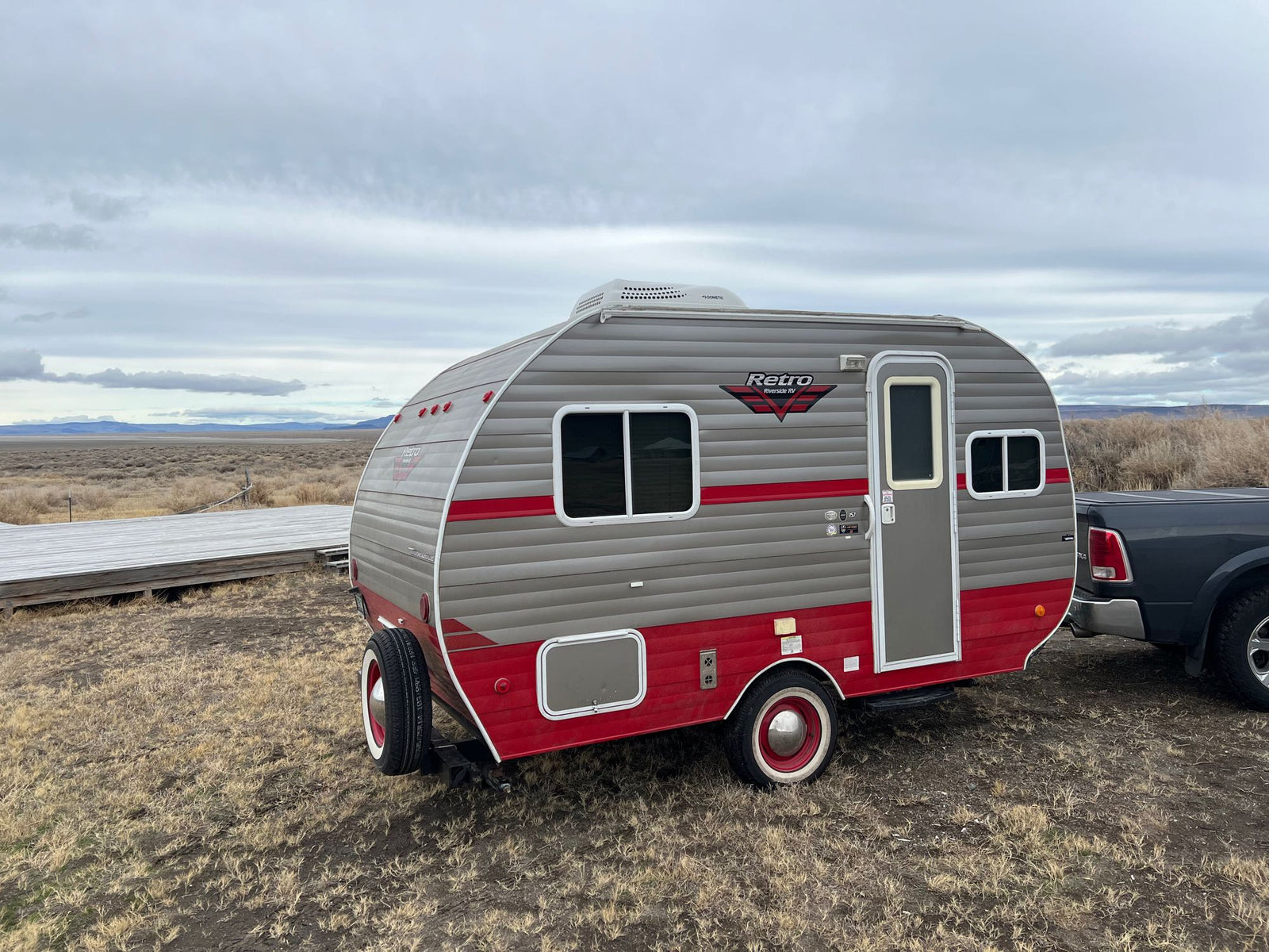 and checkerboard floor. Essentials for your trip!|Functional RV rental kitchen with a double sink