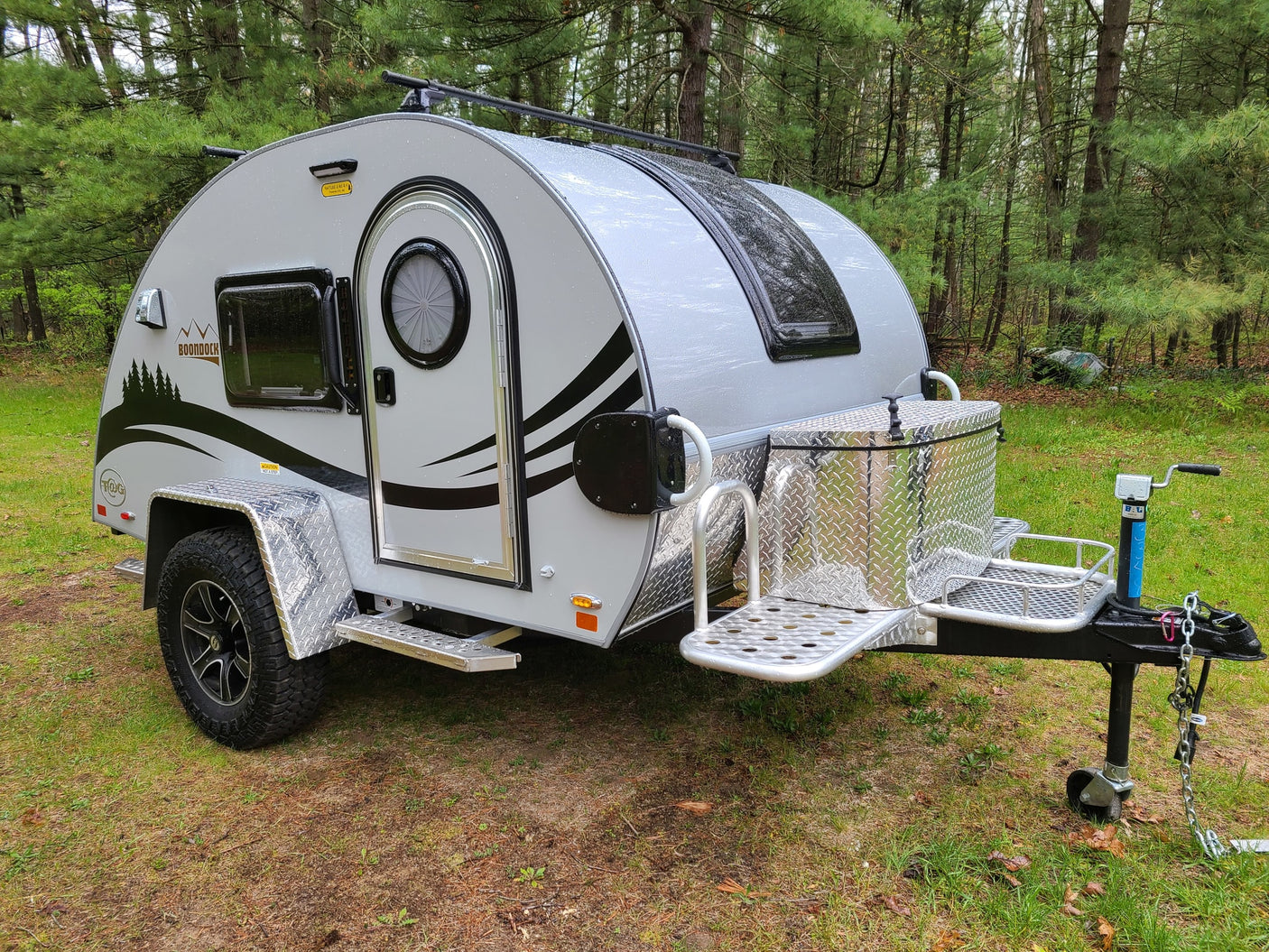 Grey Boondock teardrop RV rental parked in the forest