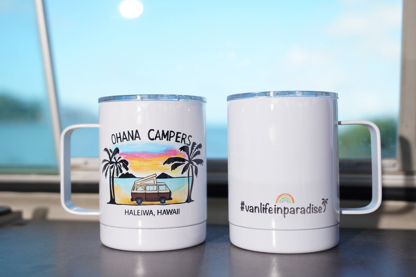 Two camper-themed travel mugs, featuring 'Ohana Campers' and '#vanlifeinparadise' designs. Great for your RV rental trips!