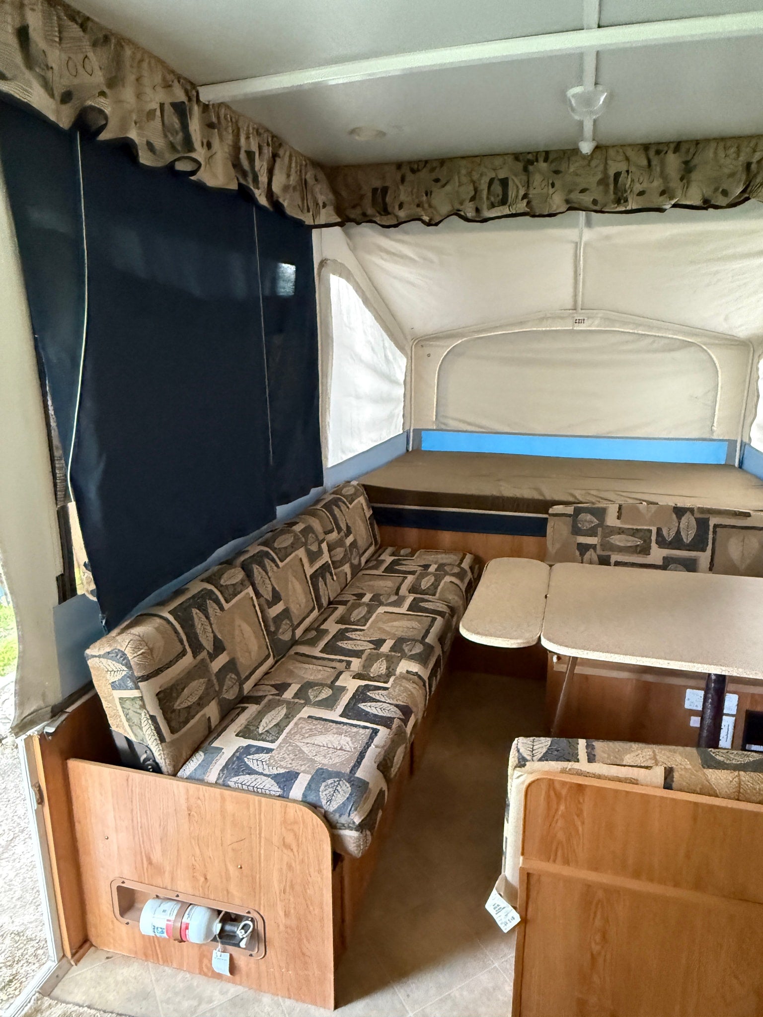 ready for camping.|Pop-up camper RV rental with an outdoor stove & fire pit