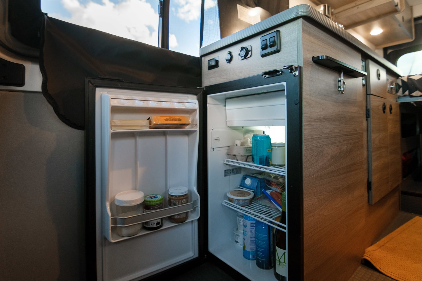 and a glimpse of the bed area.|RV rental interior showing a dinette