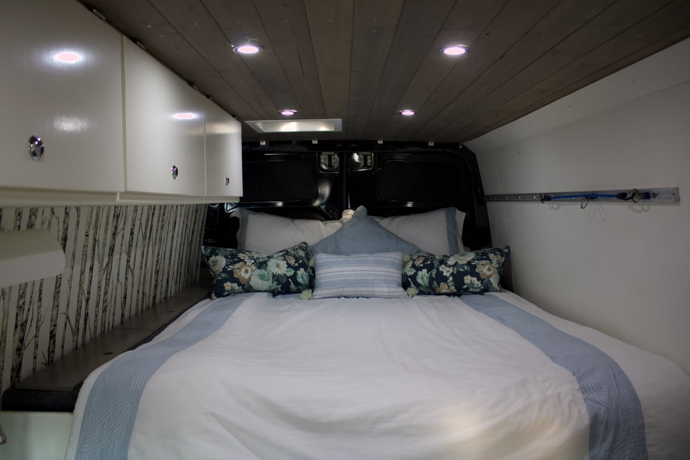 ready for off-road adventure by a rocky cliff.|Cozy RV rental bedroom with a comfy bed