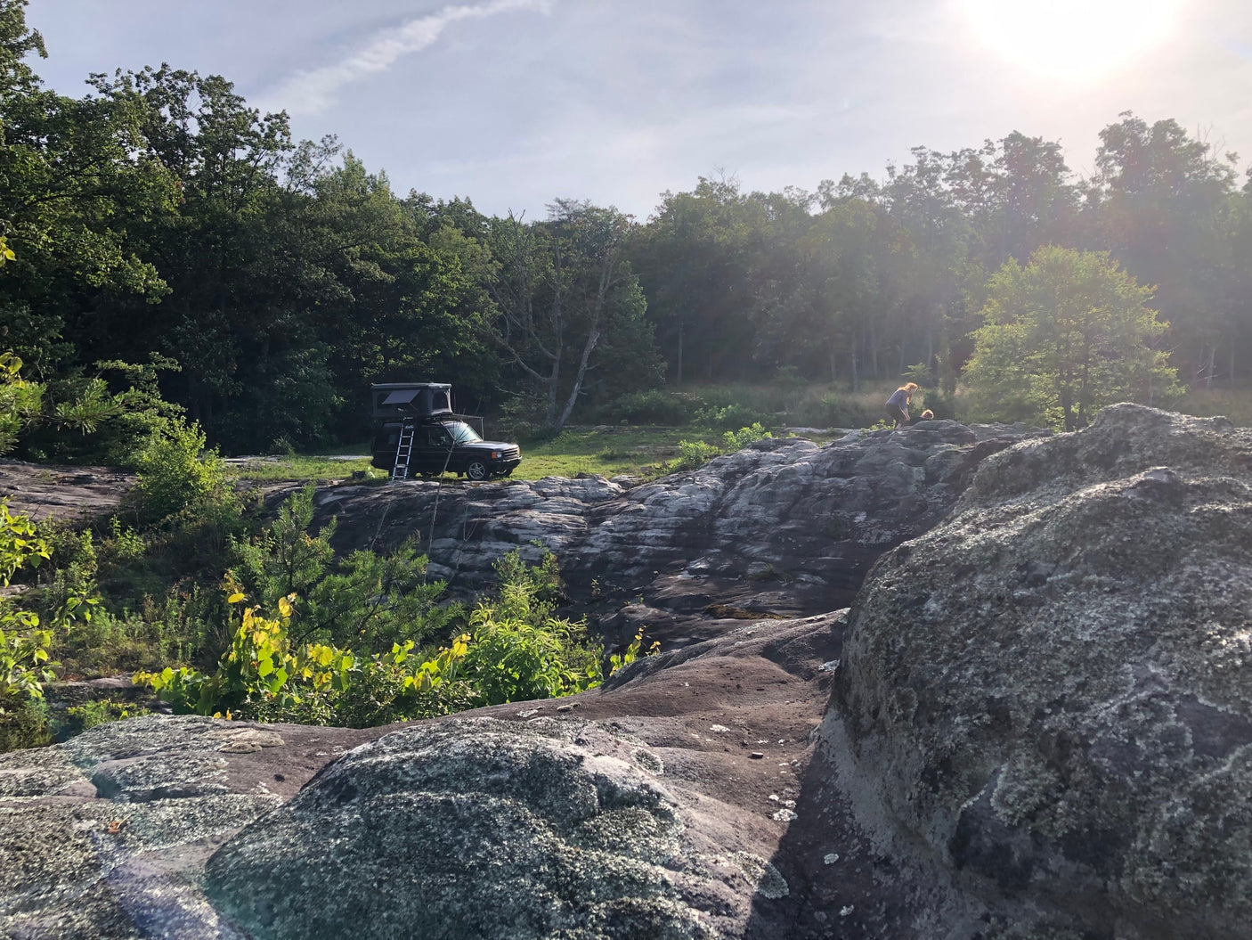 ready for overlanding. An ideal RV rental for off-grid adventures!|Overland vehicle with roof tent (like an RV rental) on rocky terrain