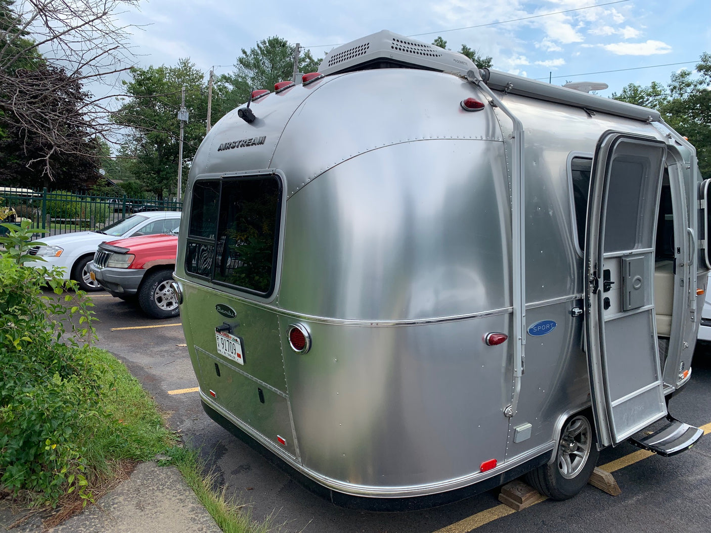 silver Airstream travel trailer with a Dometic AC unit on top