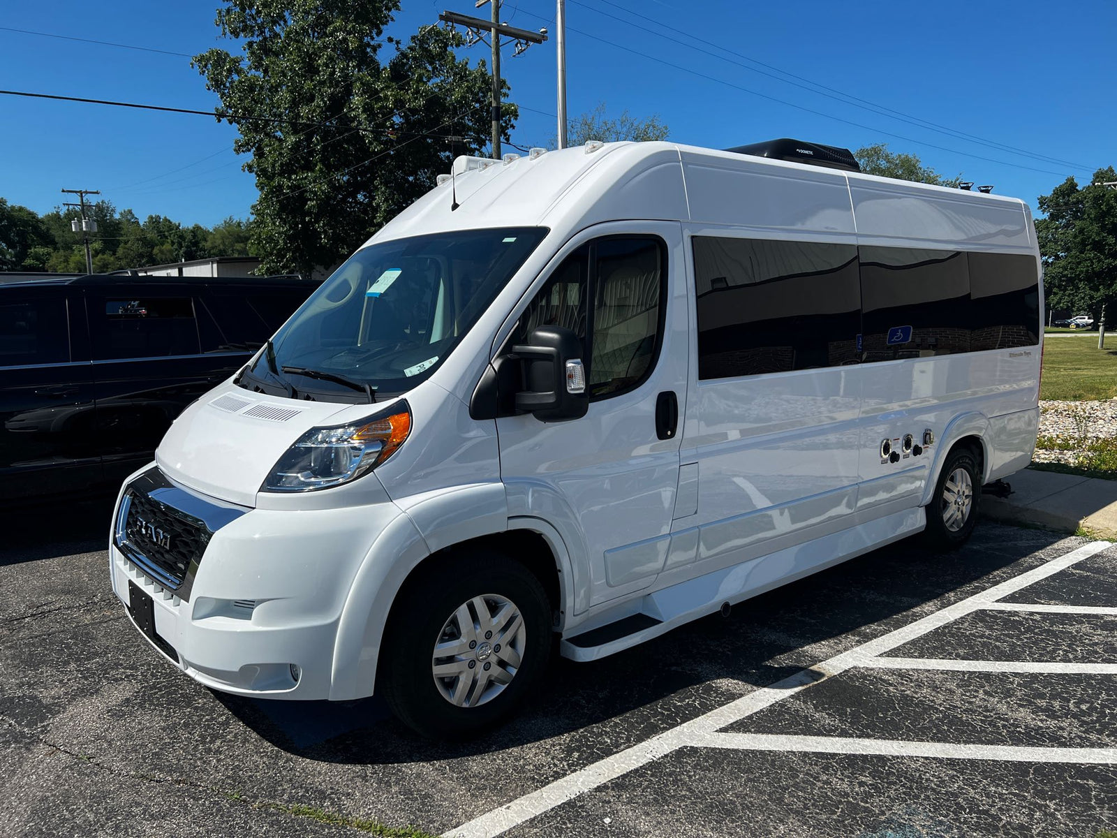 & toilet area for mobile adventures.|RV rental: ProMaster van interior featuring a full bathroom with shower/toilet and compact kitchen with microwave.|Luxury RV rental floor plan: See the Ultimate CamperVan's unique features like smart TV