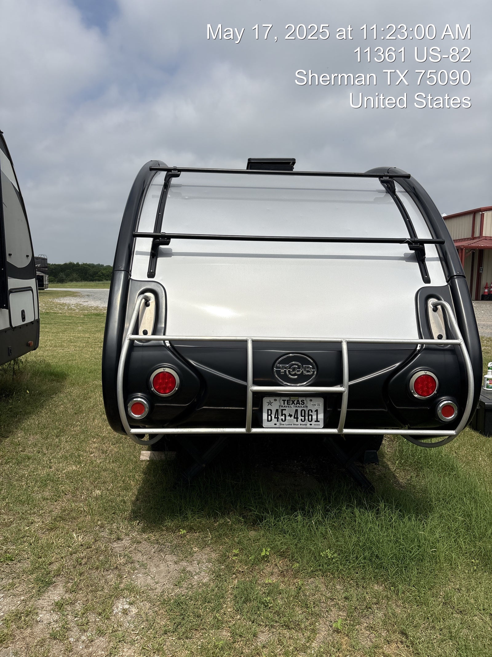 Rear view of a T@B travel trailer, a great RV rental option, with Texas plate B45-4961. Photo taken May 17, 2025.