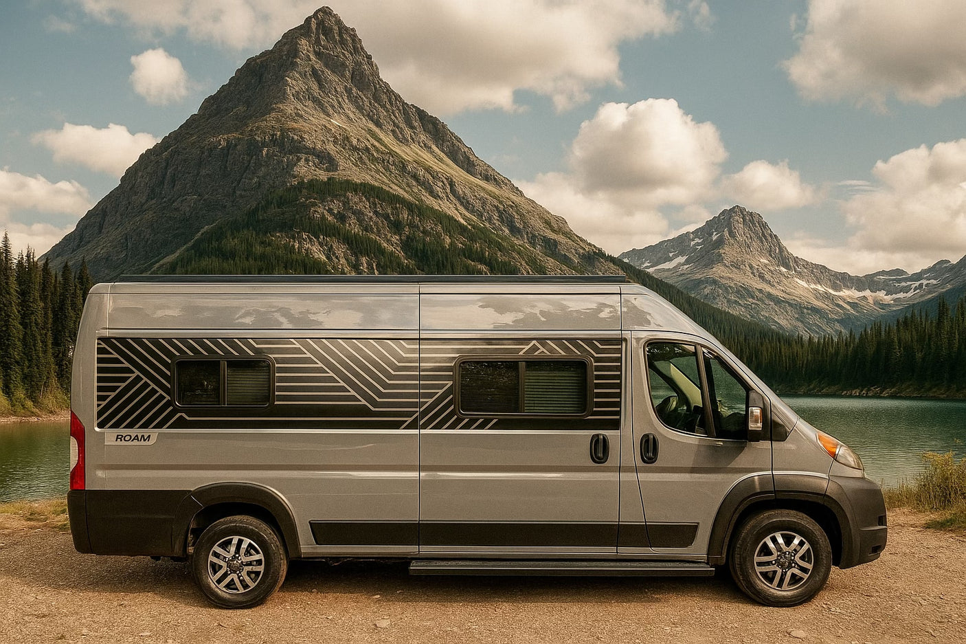 Gray ROAM rv rental camper van by a serene mountain lake, surrounded by majestic peaks and evergreen trees.