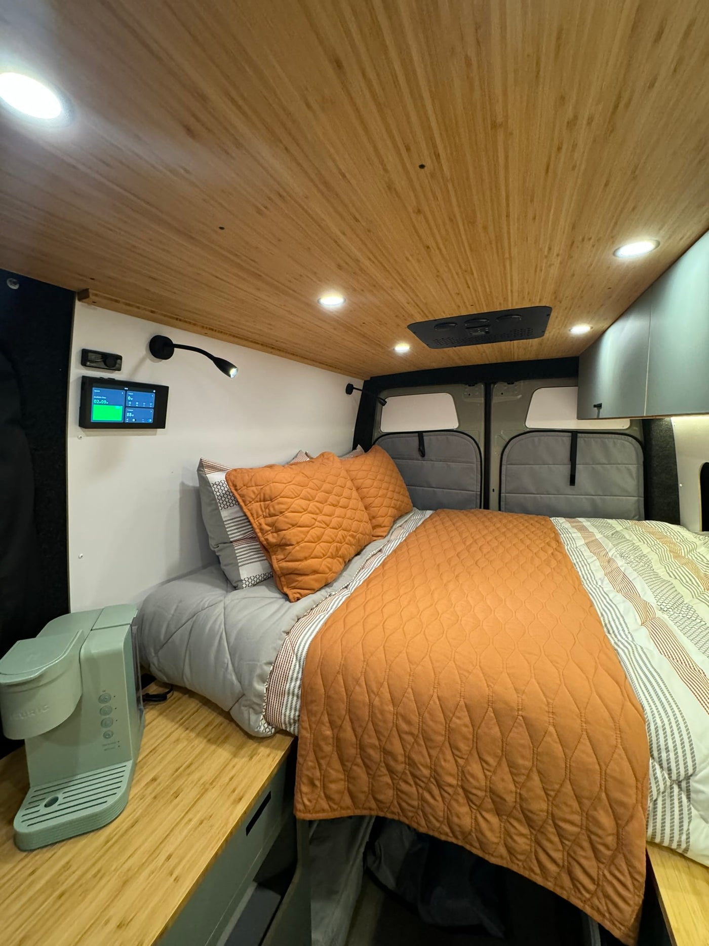 colorful sky.|Experience a modern RV rental interior with a cozy bed — photo 7