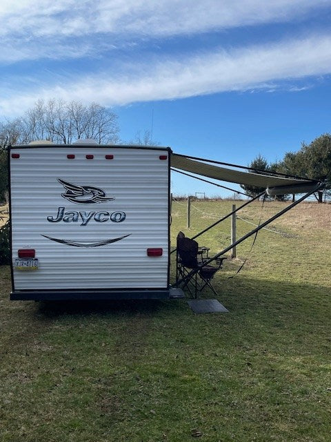 and a red truck.|White Jayco travel trailer for rv rental