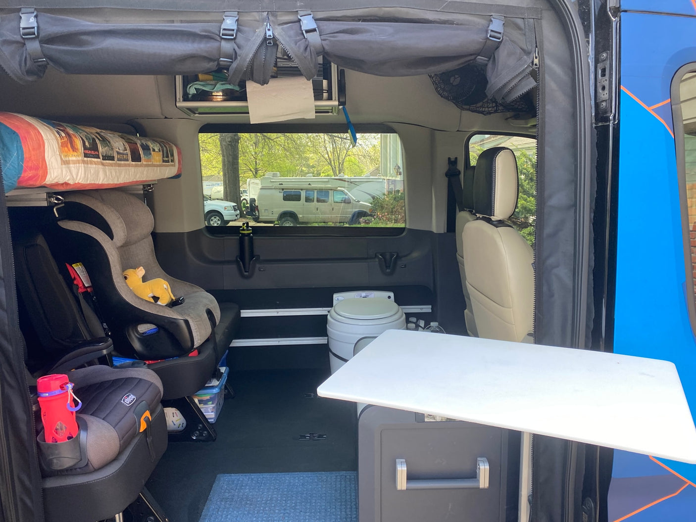 This RV rental's family-ready interior features child seats, a portable toilet, and smart storage solutions.