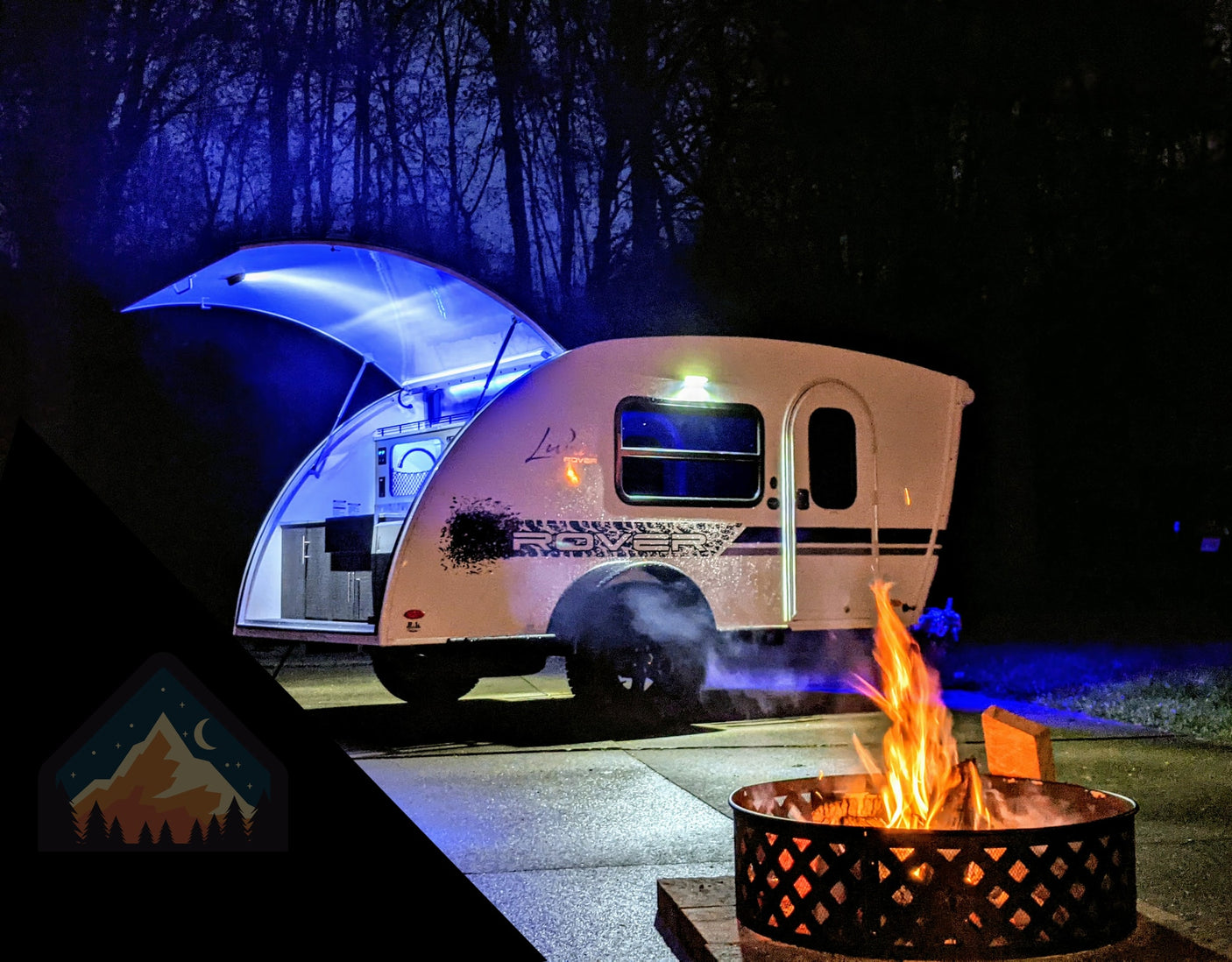 Night camping with a modern rv rental teardrop camper, featuring blue lights & a warm campfire.
