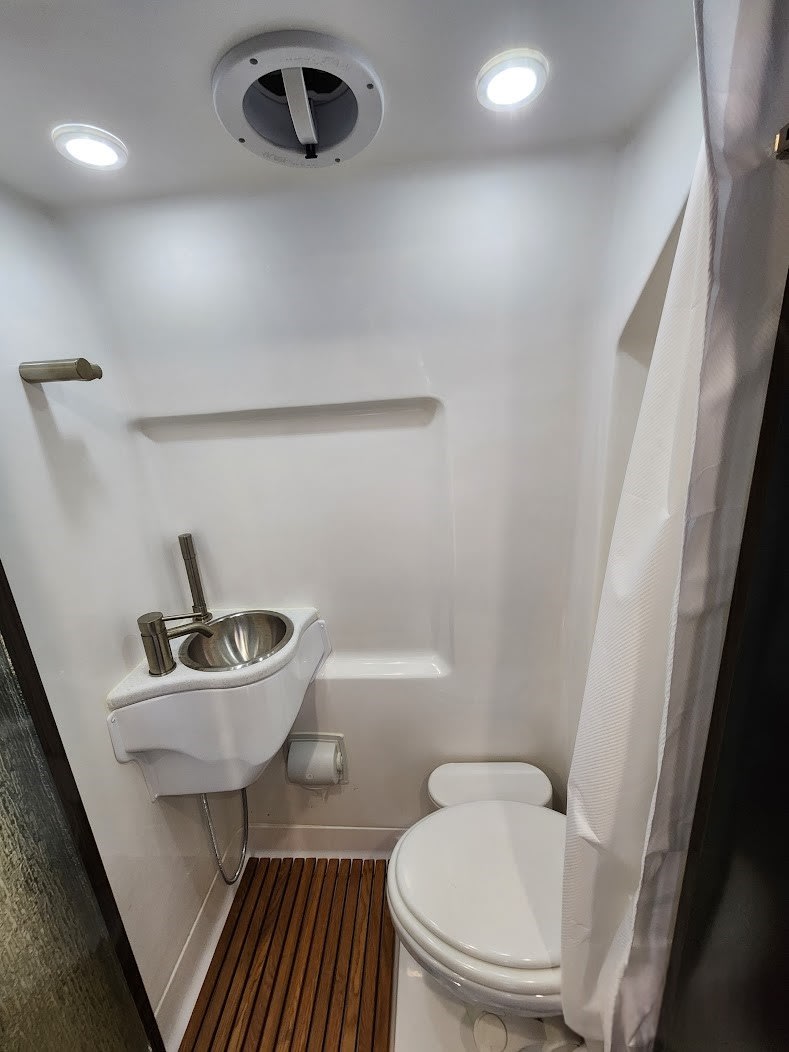and frosted glass shower door for your travels.|Experience comfort in this luxury rv rental interior