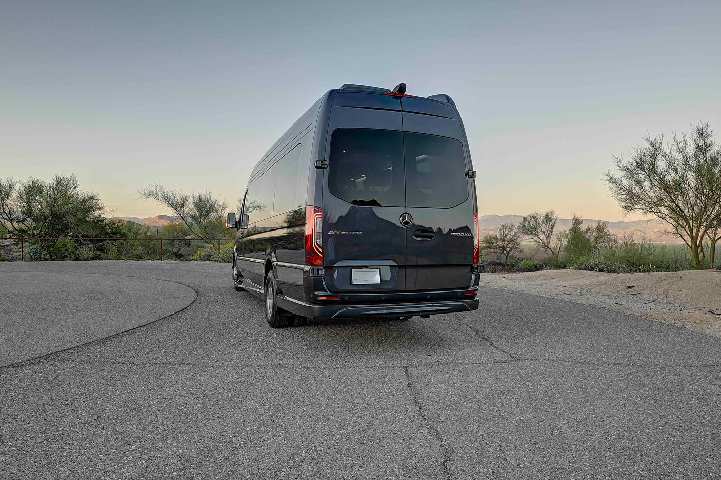Dark grey Mercedes-Benz Sprinter luxury rv rental van, perfect for desert road trip adventures.