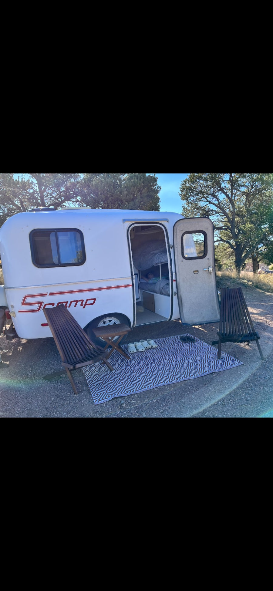 and fridge for cozy adventures.|This cozy Scamp travel trailer setup