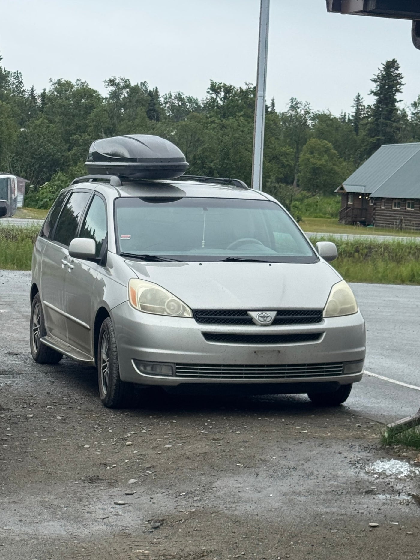 Silver minivan with a roof box — photo 1