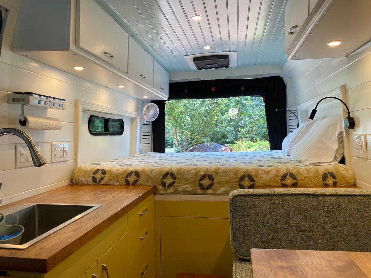and wood floor. Steps for easy access.|Bright RV rental interior: wood counters — photo 7